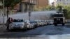 Police use water cannons against pro-Kurdish Peoples' Democratic Party members as they protest the detention of Co-mayors Gultan Kisanak and Firat Anli, in Diyarbakir, Turkey, Oct. 26, 2016.