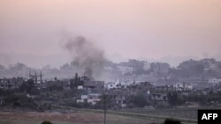 A picture taken from southern Israel along the border with the Gaza Strip shows smoke billowing in Gaza, on Oct. 29, 2023, amid ongoing battles between Israel and the Palestinian militant group Hamas. 