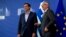 FILE - European Commission President Jean-Claude Juncker, right, speaks with Greek Prime Minister Alexis Tsipras as they arrive for a meeting at EU headquarters in Brussels, Belgium, June 3, 2015.