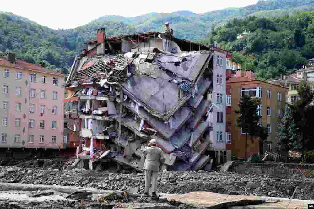 A man looks at destroyed building, in Bozkurt town of Kastamonu province, Turkey, Aug. 14, 2021.&#160;The death toll from severe floods and mudslides in coastal Turkey has climbed to at least 44, the country&#39;s emergency and disaster agency said.