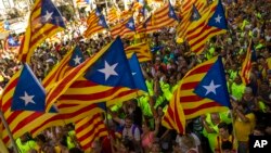 Catalans with estelada or independence flags gather during the Catalan National Day in Barcelona, Spain, Sept. 11, 2017.