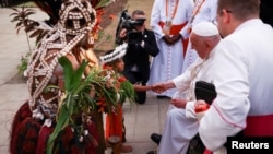 Pope Francis is welcomed by Indigenous people on the day he meets with bishops of Papua New Guinea and Solomon Islands, priests, deacons, consecrated persons, seminarians and catechists at the Shrine of Mary Help of Christians in Port Moresby, Papua New Guinea, Sept. 7, 2024. 