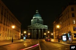 This long exposure photo shows an empty street near Paris' Pantheon square, March 21, 2020. President Emmanuel Macron said that for 15 days starting at noon Tuesday, people will be allowed to leave the place they live only for necessary activities.
