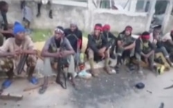 In this image taken from militant video released by the Islamic State group on Monday March 29, 2021, purporting to show fighters near the strategic north eastern Mozambique town of Palma.