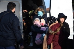 Migrants are detained by Greek authorities in the village of Thourio near the Greek-Turkish border on March 1, 2020.