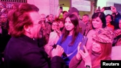 U2 rock band frontman Bono sings during a performance for Ukrainian people inside a subway station, in Kyiv