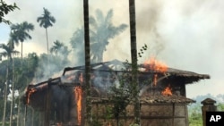 FILE - Houses are on fire in Gawdu Zara village, northern Rakhine state, Myanmar, Sept. 7, 2017.