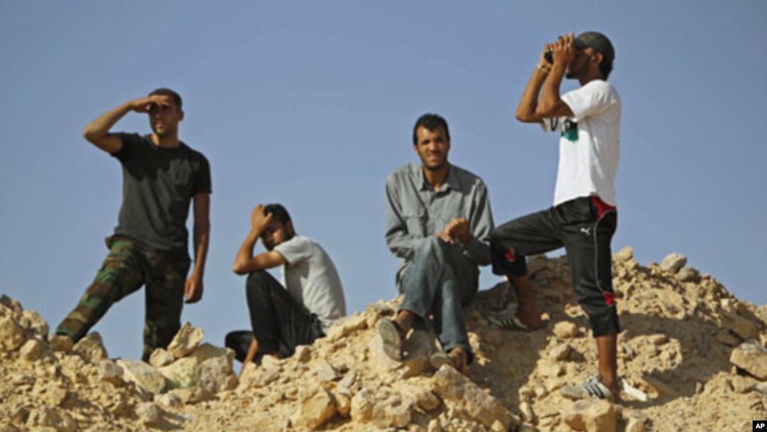Libyan rebel fighters watch the border at the frontline of Al-Qawalish in the western mountains of Libya, after a battle with forces loyal to Libyan leader Moammar Gadhafi, July 14, 2011