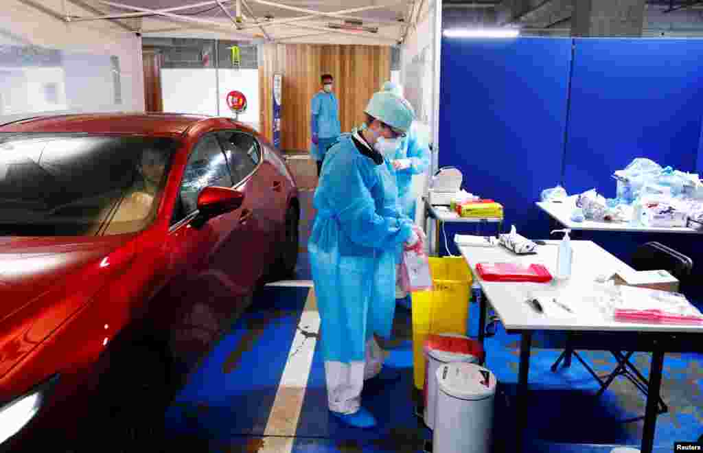 A nurse packs a nose swab after administering on to a patient in his car at a drive-in testing site for coronavirus (COVID-19) at the Regional Hospital Center in Liege, Belgium.