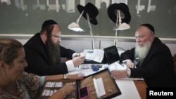 Ultra-Orthodox Jews work in the trading room of Israel's diamond exchange in Ramat Gan near Tel Aviv, October 30, 2012. 