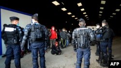 French Gendarmes break up a rave near a disused hangar in Lieuron, about 40 km (around 24 miles) south of Rennes, Jan. 2, 2021. 