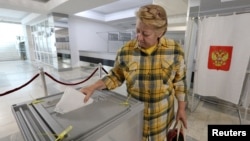 A woman casts her ballot in Sevastopol, Crimea, Ukraine on September 23, 2022. REUTERS/Alexey Pavlishak