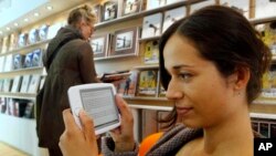 FILE - A woman reads an e-book at a book fair in Frankfurt, central Germany. 