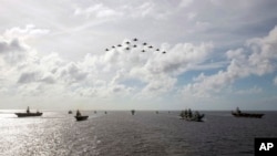 资料照片：在美国印太司令部2021年10月3日发布的这张照片中，英国皇家海军和日本海上自卫队的军舰与美国海军航母打击群会合，于当年十月在菲律宾海进行了多个航母打击群行动。（美国海军提供给美联社的图片）