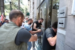 Protesters storm the office of LGBT+ campaigners at a rally against the planned March for Dignity during Pride Week in Tbilisi, Georgia, July 5, 2021.