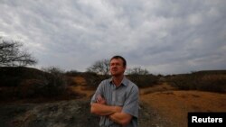 Game farmer Hennie Barnard looks out over his land near Aberdeen in the Karoo, South Africa, October 10, 2013.