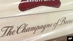 In this image provided by Comite Champagne, a label on the side of a carton of Miller High Life beer at the Westlandia plant in Ypres, Belgium on April 17, 2023. (Comite Champagne via AP)