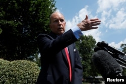 FILE - White House chief economic advisor Larry Kudlow speaks with reporters outside the West Wing of the White House in Washington, June 27, 2019.