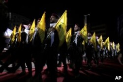 FILE - Hezbollah fighters march at a rally in a Beirut suburb, May 31, 2019. Lebanon's relations with wealthy Gulf states have been strained for years by the growing influence of the Iran-backed Hezbollah movement.