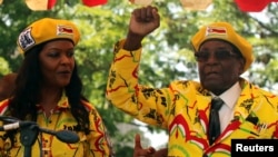 President Robert Mugabe and his wife, Grace, attend a rally of his ruling ZANU-PF party in Harare, Zimbabwe, Nov. 8, 2017. 