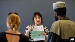 FILE - Maricopa County Elections official Joanne Tillson instructs election volunteers during a training session in Phoenix, Oct. 31, 2018.