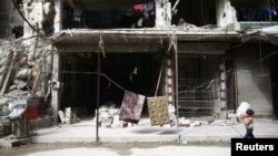 A boy is seen in the besieged town of Douma, Eastern Ghouta, in Damascus, Syria, March 8, 2018.