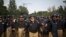 Pakistani police officers stand guard near the Parliament building after tens of thousands of protesters entered Islamabad's high-security Red Zone the night before, five days after arriving in the capital from the eastern city of Lahore in convoys, in Is