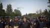 Pakistani police officers stand guard near the Parliament building after tens of thousands of protesters entered Islamabad's high-security Red Zone the night before, five days after arriving in the capital from the eastern city of Lahore in convoys, in Is