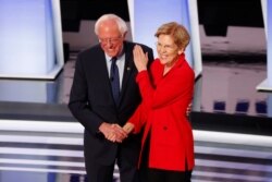 FILE - Democratic Senators Bernie Sanders and Elizabeth Warren participate in the first of two Democratic presidential primary debates hosted by CNN, at the Fox Theatre in Detroit, Michigan, July 30, 2019.