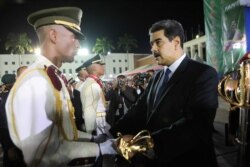 FILE - Venezuela's President Nicolas Maduro takes part in a military graduation ceremony in Caracas, July 8, 2019.