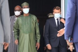 Burkina Faso President Roch Marc Christian Kabore, left, Chad President Idriss Deby, center, and France President Emmanuel Macron arrive for a picture during the G5 Sahel summit on June 30, 2020, in Nouakchott, Mauritania.