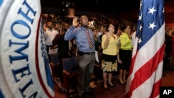 FILE - A naturalization ceremony is administered by the U.S. Citizenship and Immigration Services (USCIS) in Miami, June 5, 2014. A new report found the civil surgeons appointed by USCIS are not properly vetted. 