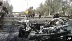 The remains of a vehicle used in a bomb attack are seen near Baghdad's Green Zone, April 18, 2011