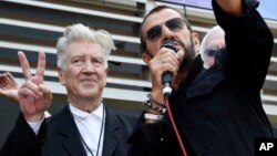 FILE - Filmmaker David Lynch, left, joins Ringo Starr onstage during a 77th birthday celebration for Starr at Capitol Records in Los Angeles, July 7, 2017. 
