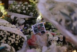 Portrait of a deadly knife attack victim is seen among flowers in front of the Notre Dame church in Nice, France, Oct. 31, 2020.