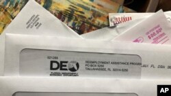 FILE - Envelopes from the Florida Department of Economic Opportunity Reemployment Assistance Program are shown.