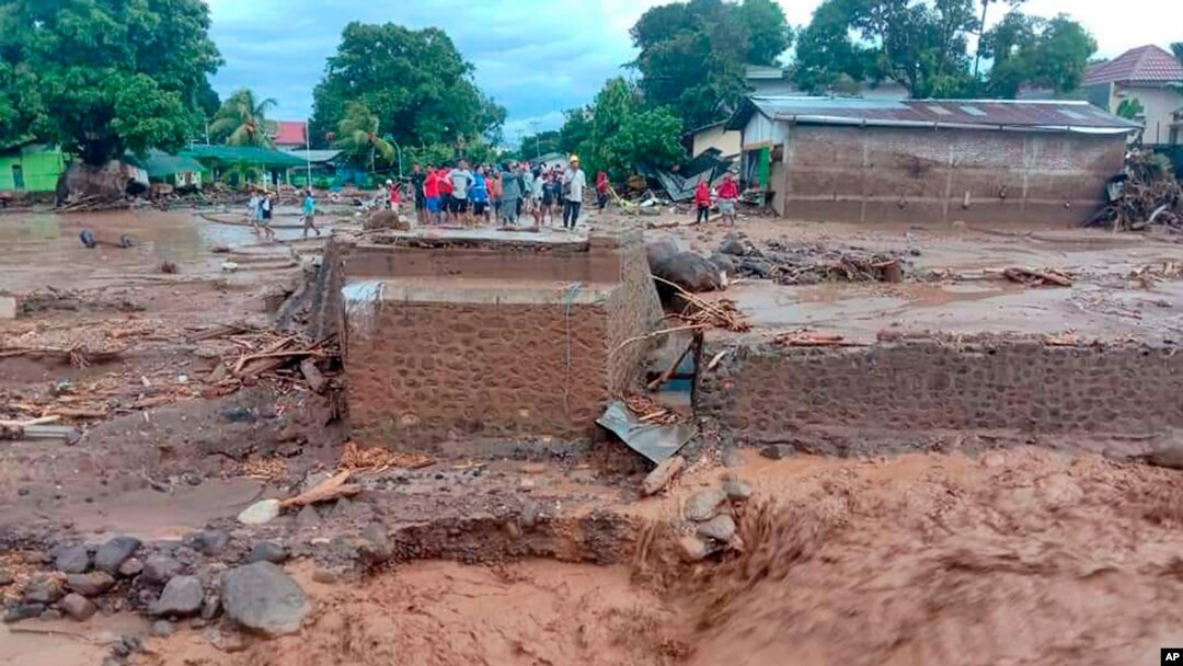 Residents inspect the damage at a village hit by a flash flood in East Flores, Indonesia, April 4, 2021.