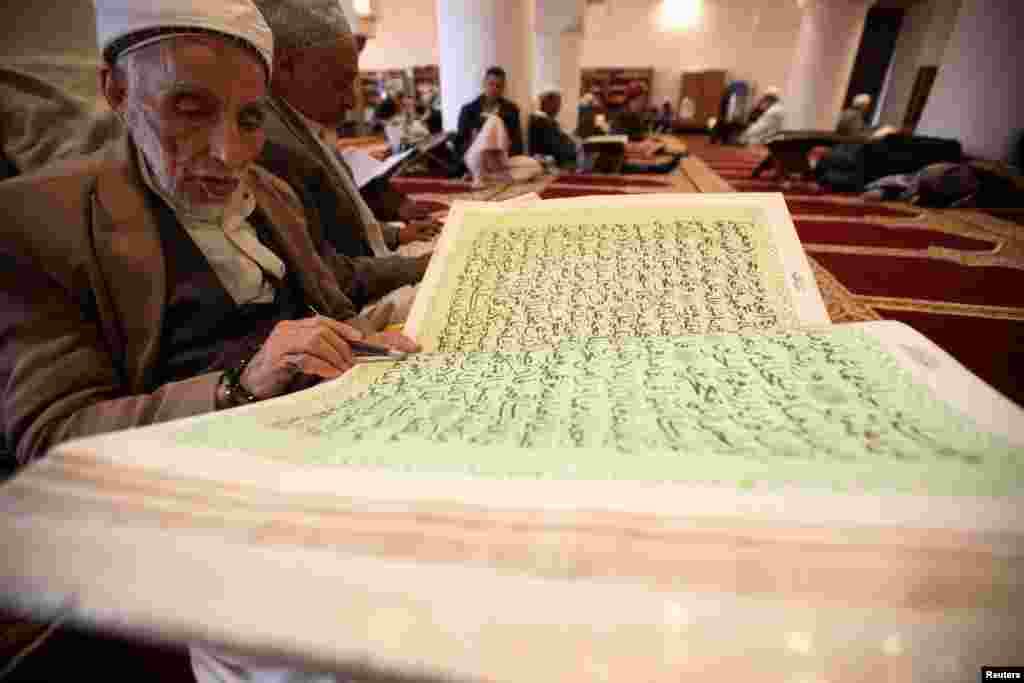 A man recites the Quran at the grand mosque in Sana&#39;a, Yemen.