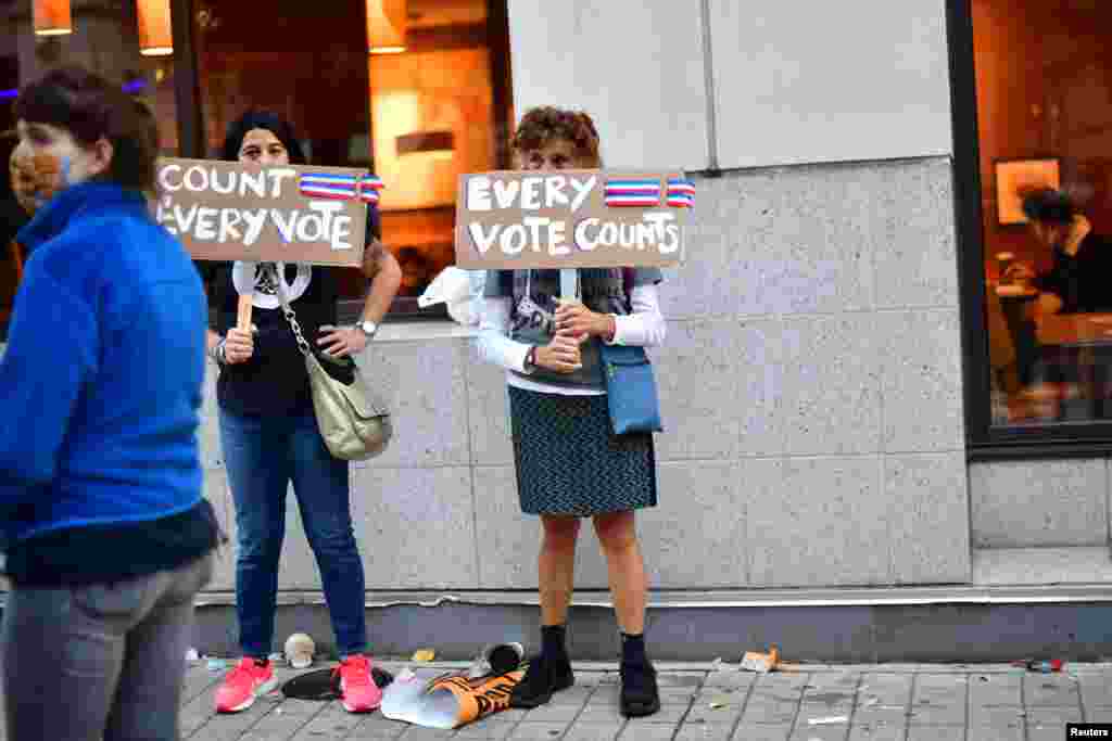 Activists hold signs saying &quot;Every Vote Counts,&quot; after Democratic presidential nominee Joe Biden overtook President Donald Trump in the Pennsylvania general election vote count, in Philadelphia, Pennsylvania, Nov. 6, 2020.