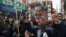 Protesters hold a picture of Hong Kong's Chief Executive Leung Chun-ying on New Year's Day in Hong Kong, Jan. 1, 2013.
