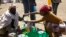 A man receives cooking oil at an emergency food aid distribution center in the village of Estayish in Ethiopia's northern Amhara region, Feb. 11, 2016.