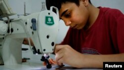 Syrian refugee child, Ahmad Abo Baker, works at a shoe workshop in Gaziantep, southeastern Turkey, June 2, 2016. Ahmad works 12 hours a day, six days a week along with his father. The boy rises at 7 am, goes straight to work and doesn’t stop except for lunch until sundown.