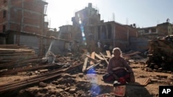 Mohan Keshari Hyanhaju, 80, sunbathes at the spot where her house stood before it was destroyed by the 2015 earthquake in Bhaktapur, Nepal, Jan. 4, 2017. People who lost their homes in the devastating earthquake that hit Nepal nearly two years ago are tired of waiting for help to rebuild.