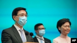 From right, Hong Kong's Chief Executive Carrie Lam, Secretary for Security Chris Tang and Chief Secretary John Lee attend a news conference in Hong Kong, June 25, 2021, as Beijing continues to clamp down on free speech and political opposition.