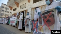 Palestinians hold posters depicting Bahrain's King Hamad bin Isa Al Khalifa, U.S. President Donald Trump and Israeli Prime Minister Benjamin Netanyahu during a protest against Bahrain's move to normalize ties to Israel, in the Gaza Strip, Sept. 12, 2020.