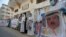 Palestinians hold posters depicting Bahrain's King Hamad bin Isa Al Khalifa, U.S. President Donald Trump and Israeli Prime Minister Benjamin Netanyahu during a protest against Bahrain's move to normalize ties to Israel, in the Gaza Strip, Sept. 12, 2020.