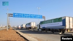 Trucks carrying aid from Saudi Arabia cross into Syria through Nasib Border Crossing, also known as Jaber Border Crossing, an international border crossing between Syria and Jordan, Jan. 6, 2025. (Saudi Press Agency/Handout via Reuters)