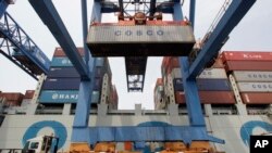 FILE - A container ship from China is offloaded at Massport's Conley Terminal in the port of Boston, Massachusetts, July 13, 2012. 