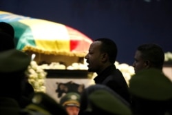 Ethiopian Prime Minister Abiy Ahmed walks past the coffin of Army Chief of Staff Seare Mekonnen, who was shot by his bodyguard, during a memorial ceremony in Addis Ababa, Ethiopia, June 25, 2019.