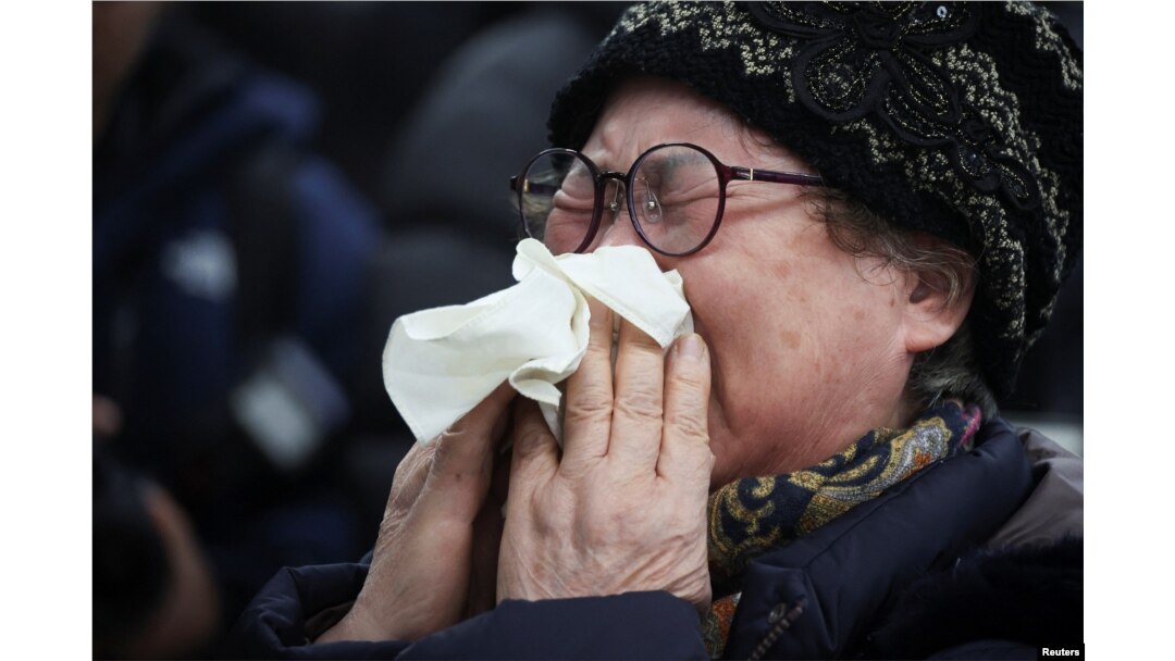 A relative of a passenger of the aircraft that crashed after it went off the runway reacts at Muan International Airport in Muan, South Korea, Dec. 29, 2024.